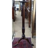 An Antique mahogany torcher stand, on fluted column and tripod legs, label for Muirhead Moffatt &