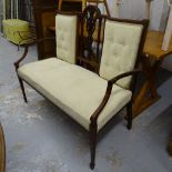 An Edwardian mahogany-framed and upholstered 2-seater settee, on square tapered legs and spade feet,