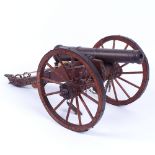 A scratch-built model field cannon with bronze barrel, on metal-mounted wooden carriage, barrel