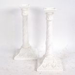 A pair of Royal Worcester white glaze porcelain candlesticks with relief moulded decoration, pattern