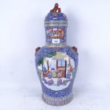 A Chinese porcelain jar and cover, with decorated panels on enamelled blue ground, height 53cm
