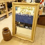 A pine-framed wall mirror, and a turned wood vase