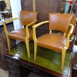 A pair of 1930s leather-upholstered open armchairs