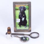 A silver-handled magnifying glass by S Mordan & Company, a rectangular silver-fronted photo frame,