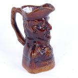 A 19th century treacle-glazed stoneware pottery jug commemorating the Duke of Wellington, died
