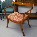 A Egyptian Revival armchair, with upholstered seat and gilt decoration