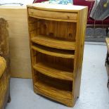 A modern hardwood bow-front open bookcase, with single drawer, W50cm