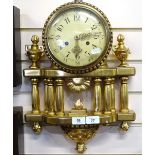 An ornate carved giltwood-cased wall clock, with fluted columns and brass 8-day striking movement,