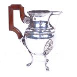 A 19th century French silver cream jug, with rosewood handle and splayed legs, height 10cm