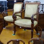 A pair of 19th century Empire style armchairs with scrolled arms