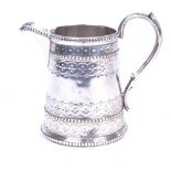 A Victorian silver cream jug, with allover engraved decoration, height 9cm