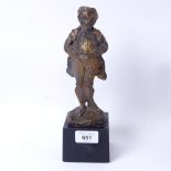 A modern resin sculpture of a man in a dress coat, indistinctly signed, overall height 25cm