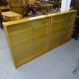 A large beech-framed hanging display cabinet, with 4 glazed doors and fitted glass shelves,