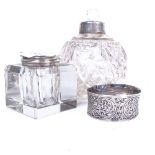 A glass inkwell with silver mounts, a silver napkin ring, and cut-glass scent bottle with silver