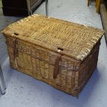 A large wicker laundry basket with leather straps, W74cm, H40cm, D52cm