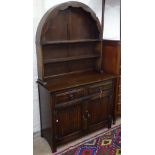 A Dutch oak dome-top dresser, base fitted with drawers and linenfold panelled cupboards, on stile