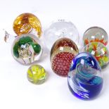 A snail design paperweight, height 9cm, and 7 other glass paperweights