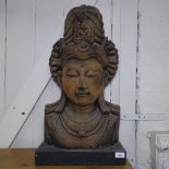 A large Tibetan carved hardwood bust of Guanyin, H75cm