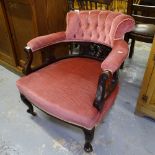 A late Victorian button-back upholstered bow-arm parlour chair, on cabriole legs