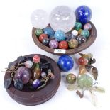 A wooden bowl containing various hardstone and crystal balls, largest 10cm