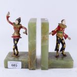 A pair of Art Deco green onyx harlequin clown bookends, surmounted by painted and gilt-bronze
