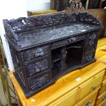 An ornate ebonised table-top cabinet, with raised gallery, fitted drawers and cupboards, with