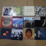 Various vinyl LPs and records, including the Rolling Stones, Bob Dylan, and John Lennon