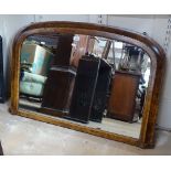 A Victorian walnut and satinwood-strung arch-top over mantel mirror, W106cm, H70cm