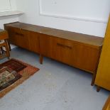 A mid-century Danish teak sideboard, with 4 stylised shaped doors, on square legs, L240cm, H75cm,