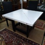 A Conran envelope extending dining table, the white formica top on black lacquered 4-gateleg base,