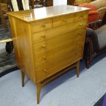 A mid-century teak chest of 5 long drawers, on splayed leg base, label for "Handycraft" Furniture,