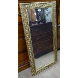 A modern embossed gilt-framed rectangular wall mirror, 57cm x 116cm