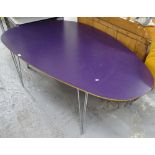 A free-form asymmetrical Danish design dining table, with purple laminated ply top, on chrome