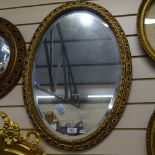 A modern oval gilt-framed bevel-edge wall mirror, overall height 66cm