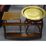 An engraved brass-top occasional table, a hanging plate rack, and a suitcase stand