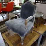 A limed oak style and upholstered open armchair