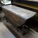An Antique carved oak gateleg table, on baluster turned legs, W120cm, H72cm