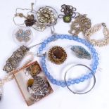 A tin of mixed costume jewellery, pearls, stone set necklaces, silver costume jewellery