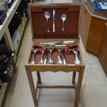 An oak canteen on stand, and small quantity of plated cutlery