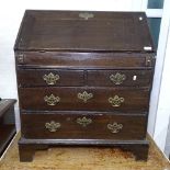 An early 18th century oak bureau, with a fitted and well interior, 2 short and 2 long drawers under,