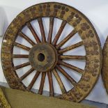 An Antique heavy wooden gun carriage wheel with steel rim and studwork decoration, H113cm