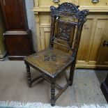 A carved and panelled oak hall chair
