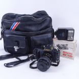 A Canon camera, various accessories, in carrying case