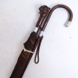 An early 20th century silver-mounted bamboo walking stick, and a novelty carved wood dog's-head