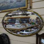 A 19th century oval brass-framed bevel-edge wall mirror, overall length 80cm
