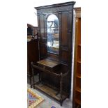 A 1920s panelled oak mirror-back hallstand, W90cm, H195cm