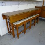 A mid-century teak narrow drop leaf table, and 4 matching stools, table length 155cm, height 70cm