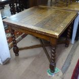 A square oak draw leaf dining table, on cross stretchers and barley twist legs