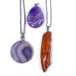 An amber and silver necklace, a polished agate pendant, and another (3)