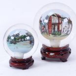 2 interior reverse painted glass ball scenes of Rye, on wood stands, largest diameter 11cm (2)